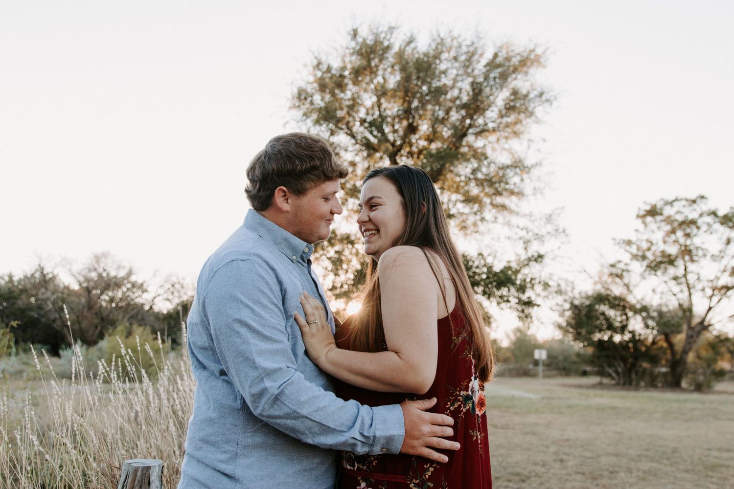 San Antonio Engagement Photography. A romantic sunset photo session in a field with tall grass and trees.