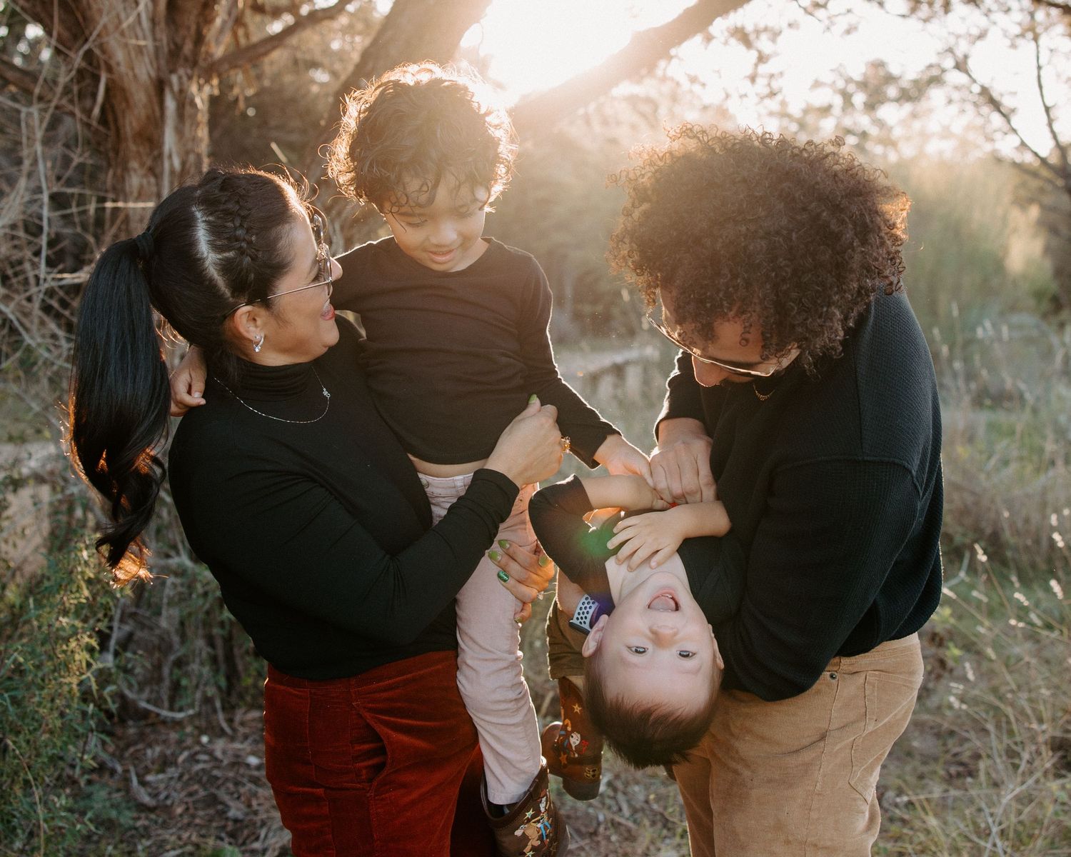 San Antonio Family Photography. Family enjoying playful moments together outdoors during sunset.