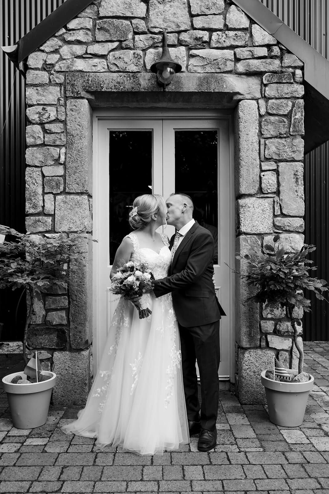 Newlyweds sharing a candid moment in the Irish countryside.