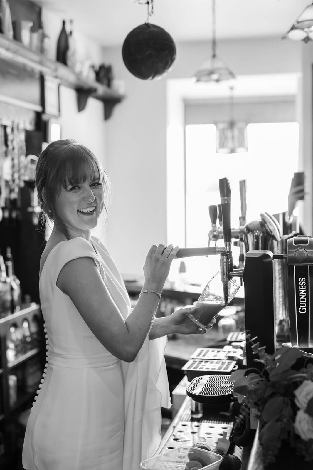 A black and white series of images showing someone enjoying drinks and conversation at a bar counter.