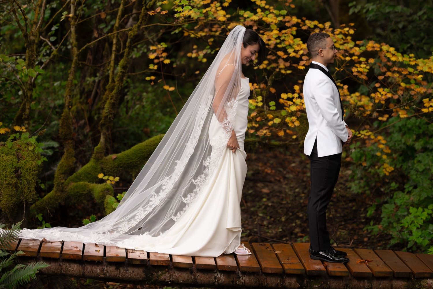 The bride walks up to the groom for first looks on their autumn wedding day. Edited with moody contrast for a timeless, clean style.