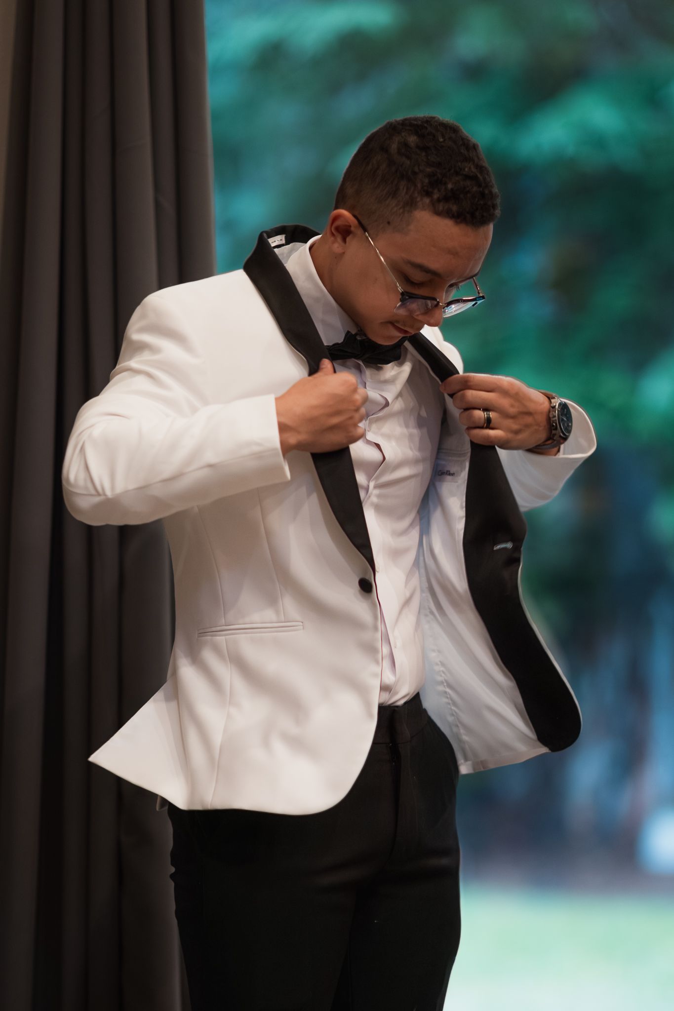 Groom puts on his suit jacket in preparation for his Mount Rainier bnb micro-wedding in Ashford. Edited to be timeless and crisp.