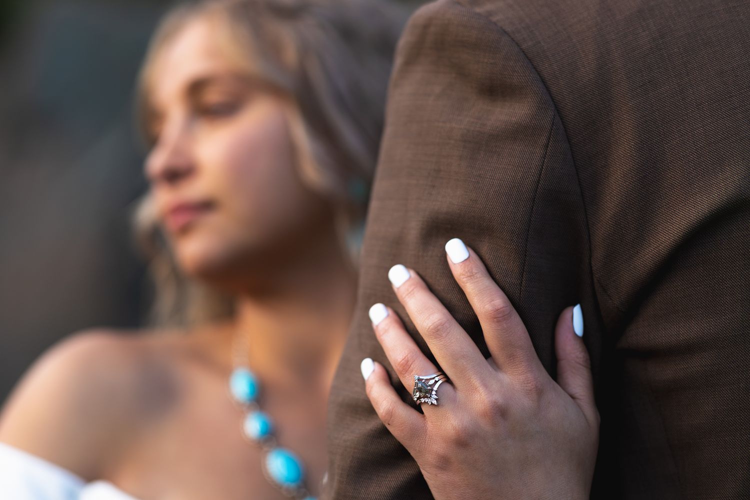 Dramatic focus on a custom engagement and wedding band set during an elopement at Mount Rainier.
