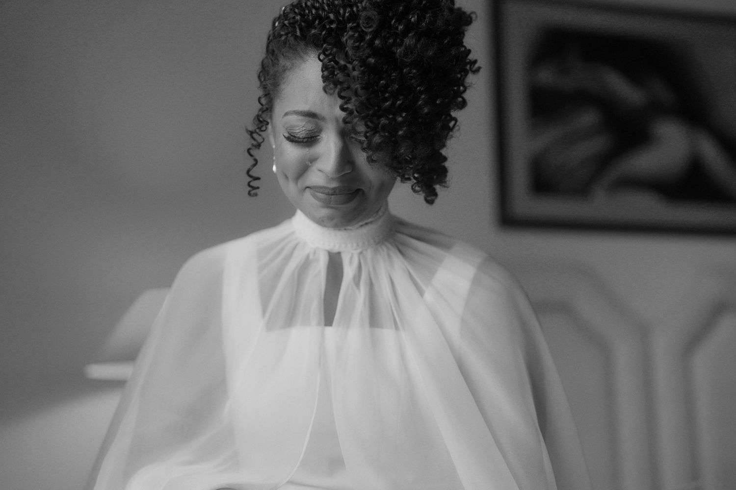 A black and white photo series shows a bride in a white wedding dress with natural curly hair and a high neckline.