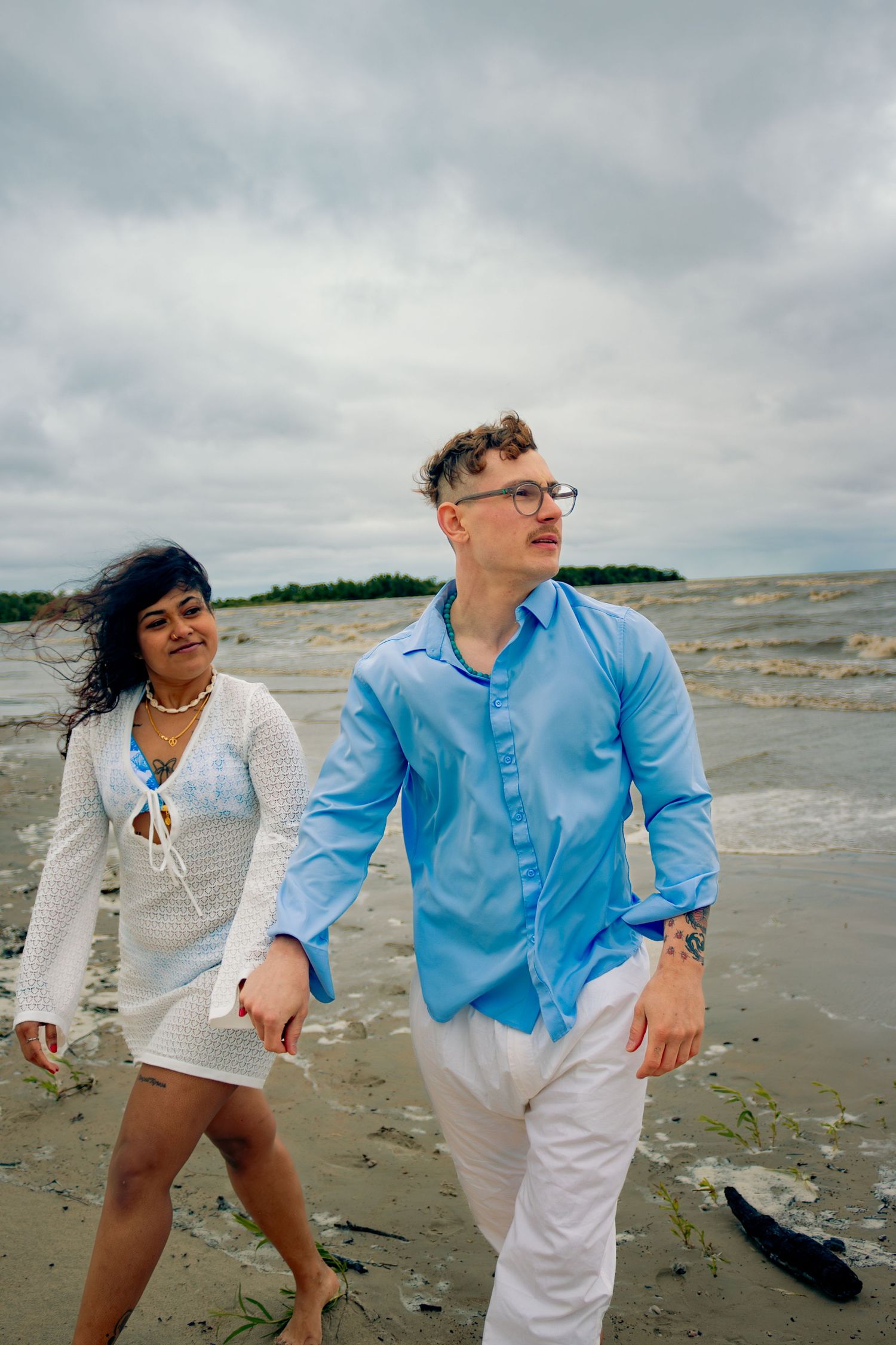 young couple posing at the beach