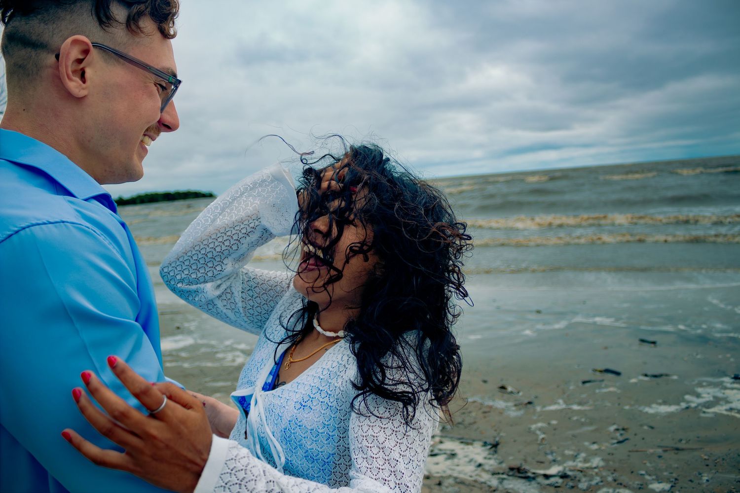 young couple posing at the beach