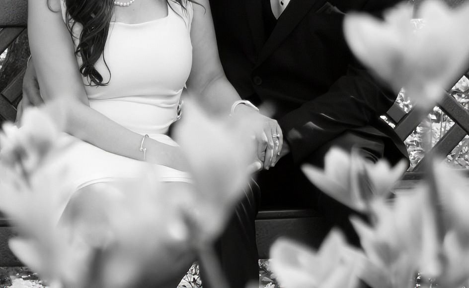 black and white photo married couple holding hands