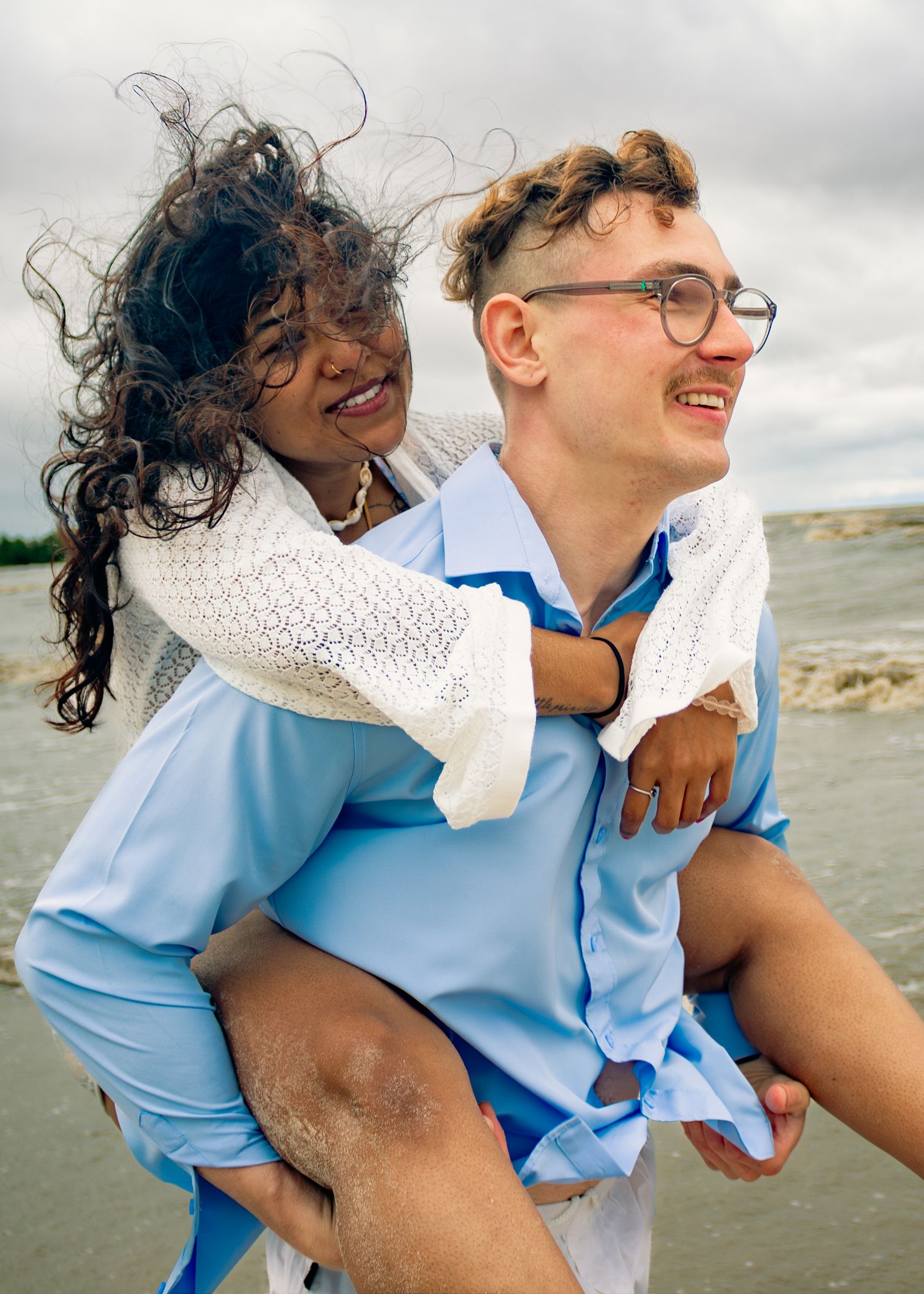 young couple posing at the beach