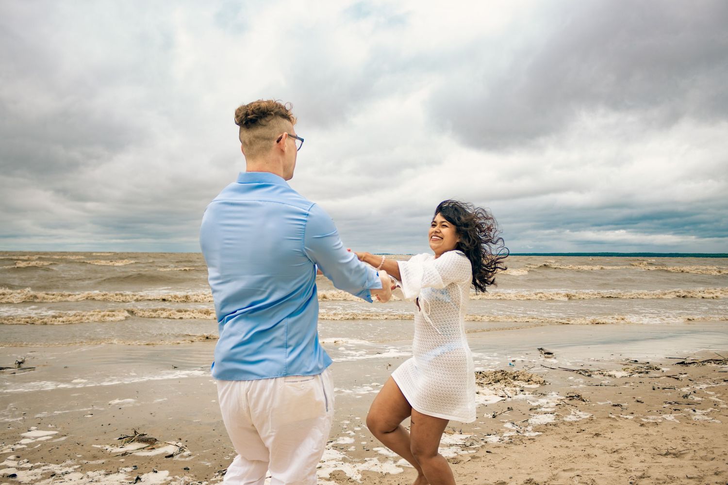 young couple posing at the beach
