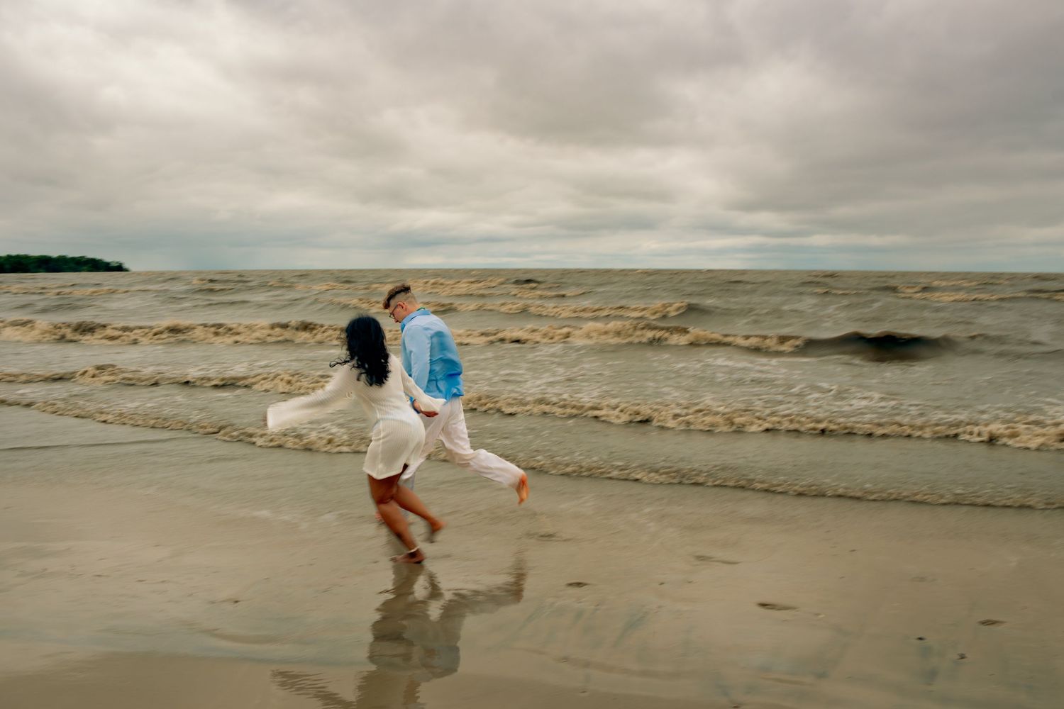 young couple posing at the beach