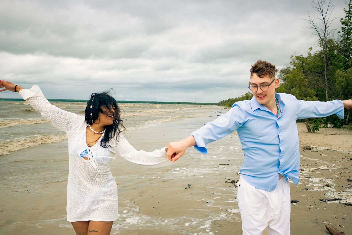 young couple posing at the beach