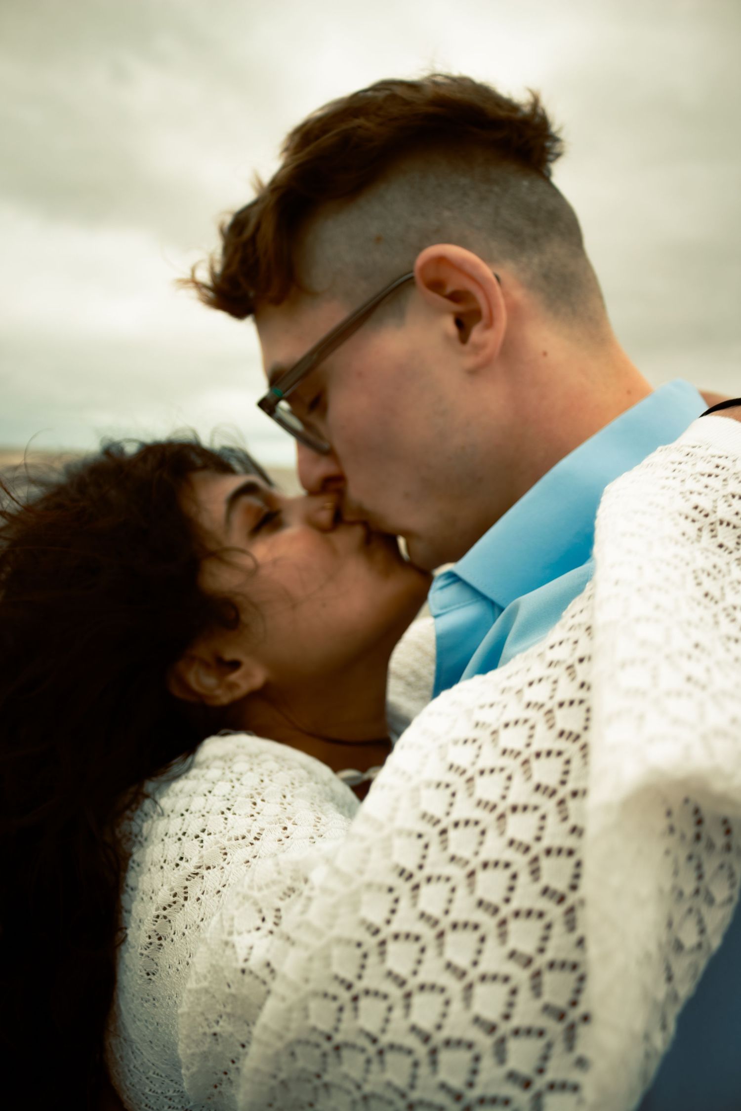 young couple posing at the beach