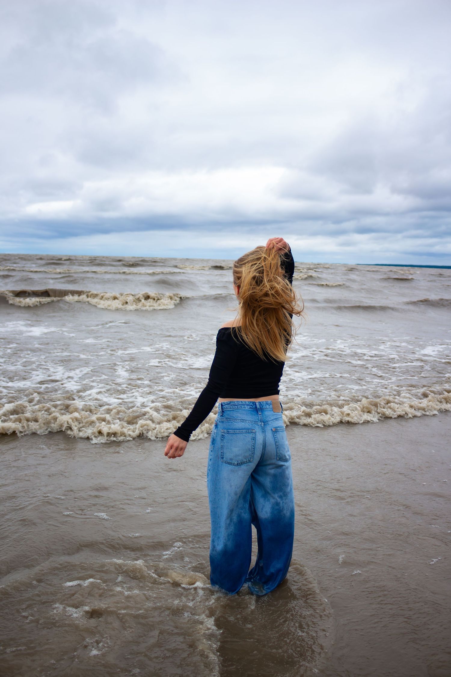 young woman posing at the beach