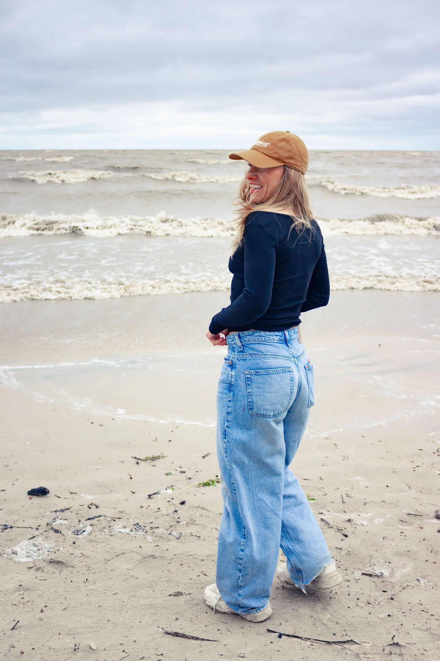 young woman posing at the beach