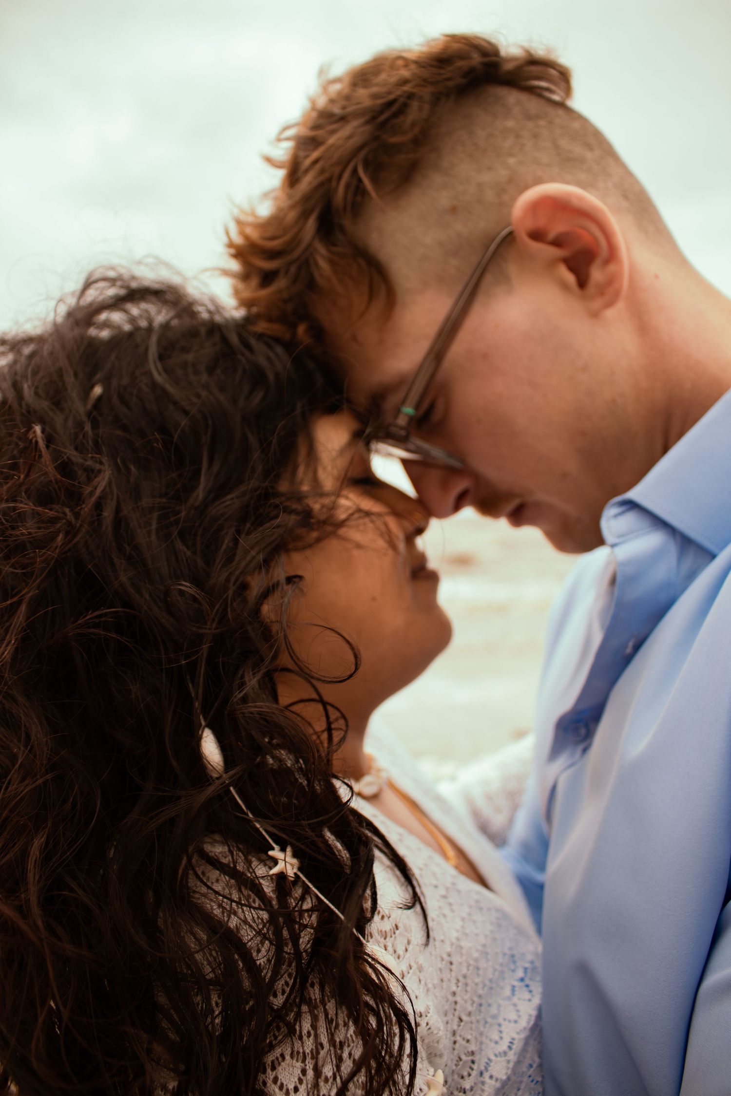 young couple posing at the beach