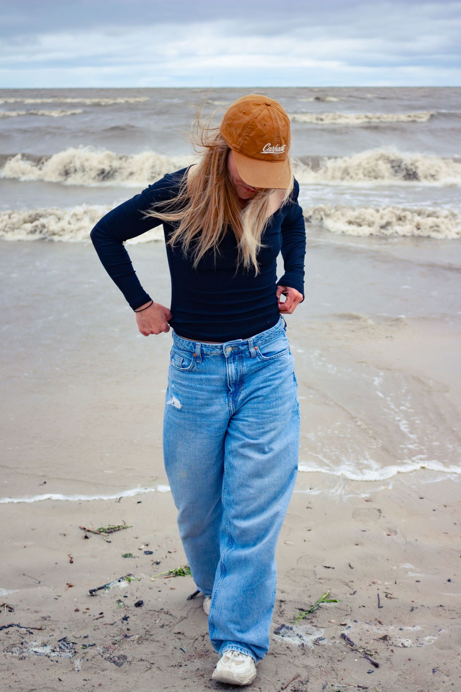 young woman posing at the beach