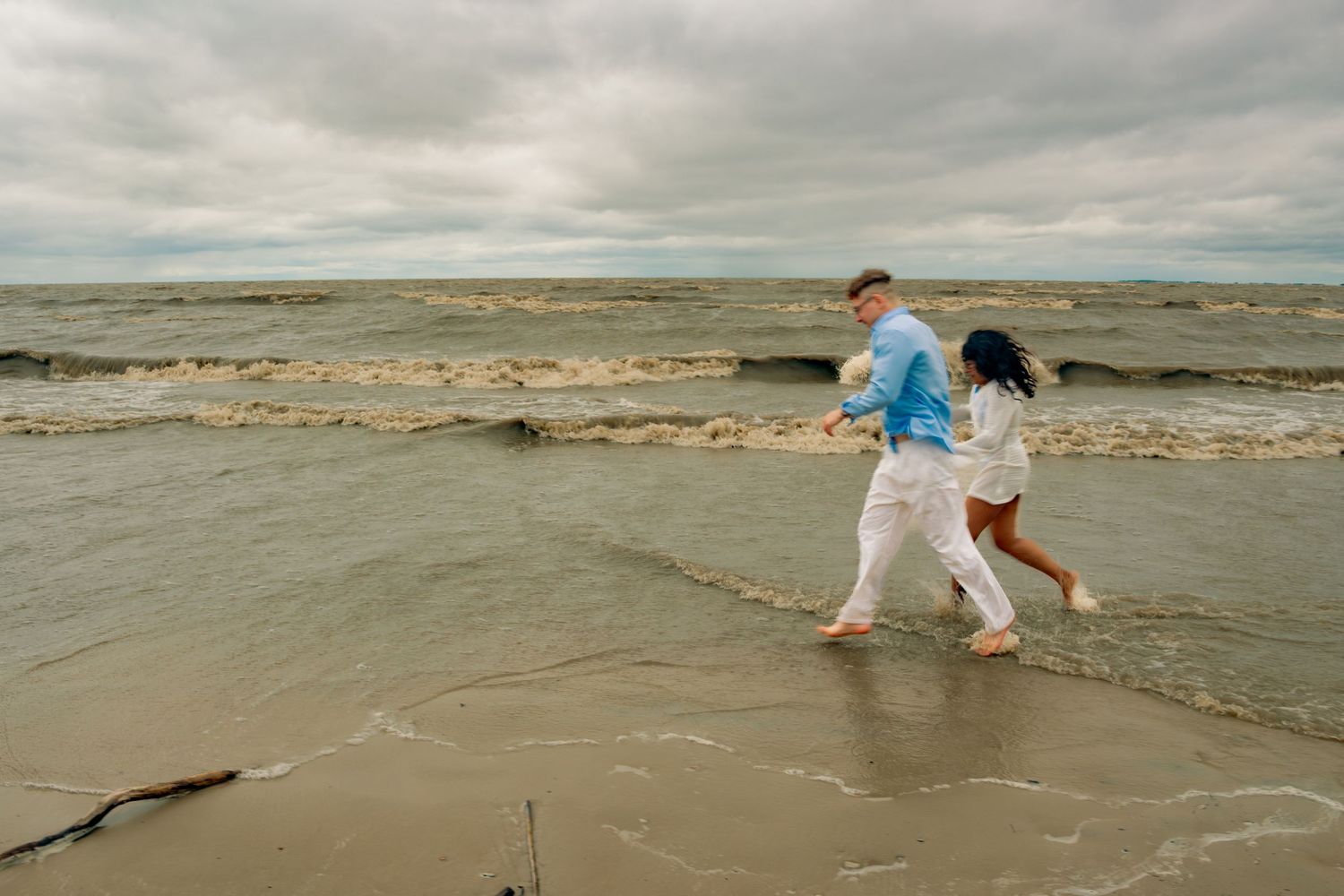 young couple posing at the beach