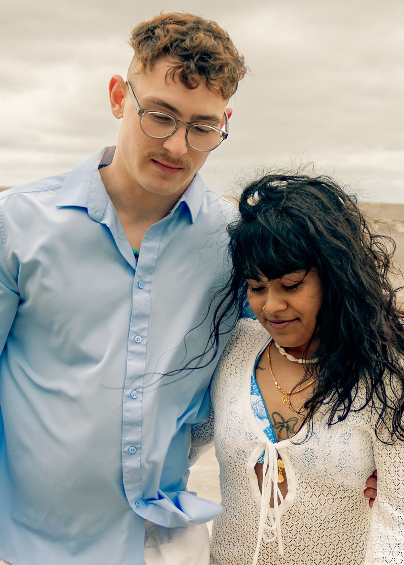 young couple posing at the beach