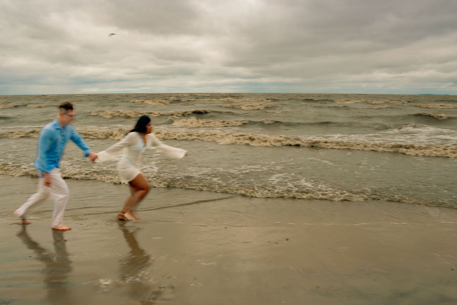 young couple posing at the beach