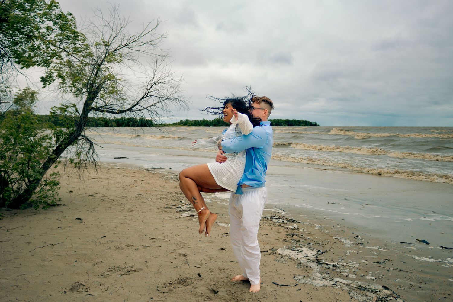 young couple posing at the beach