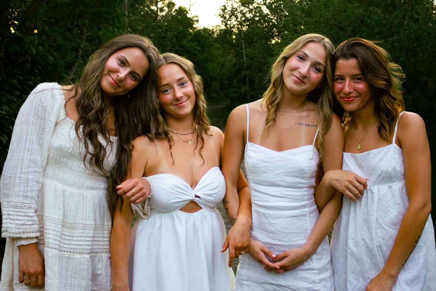 four female friends posing in the forest