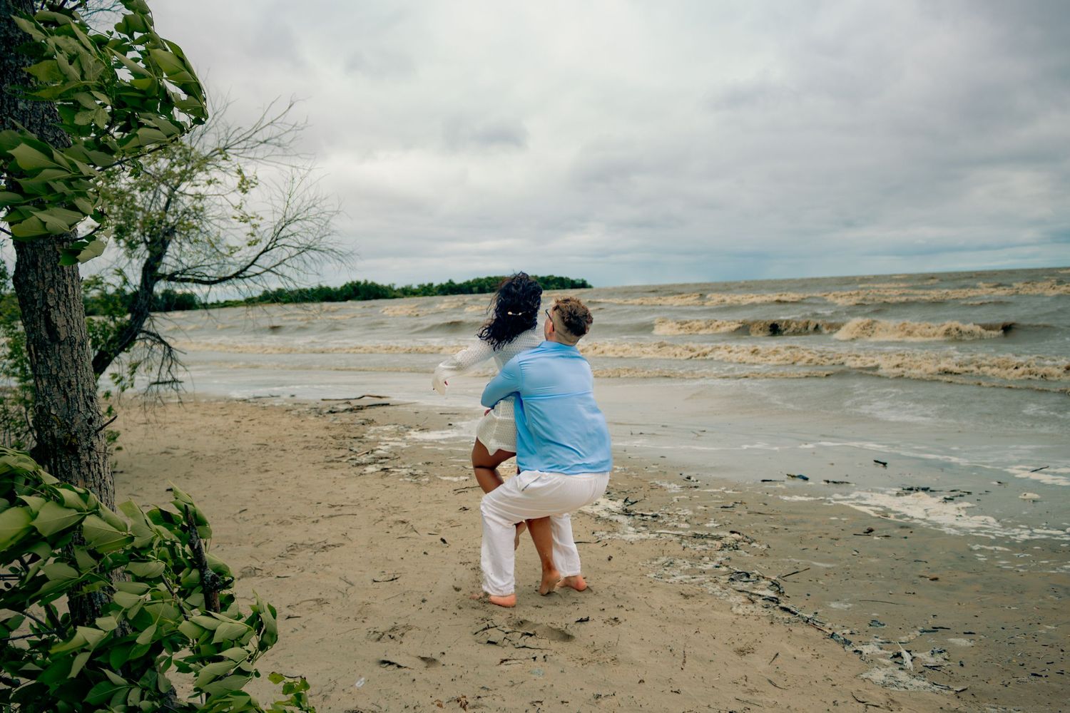young couple posing at the beach