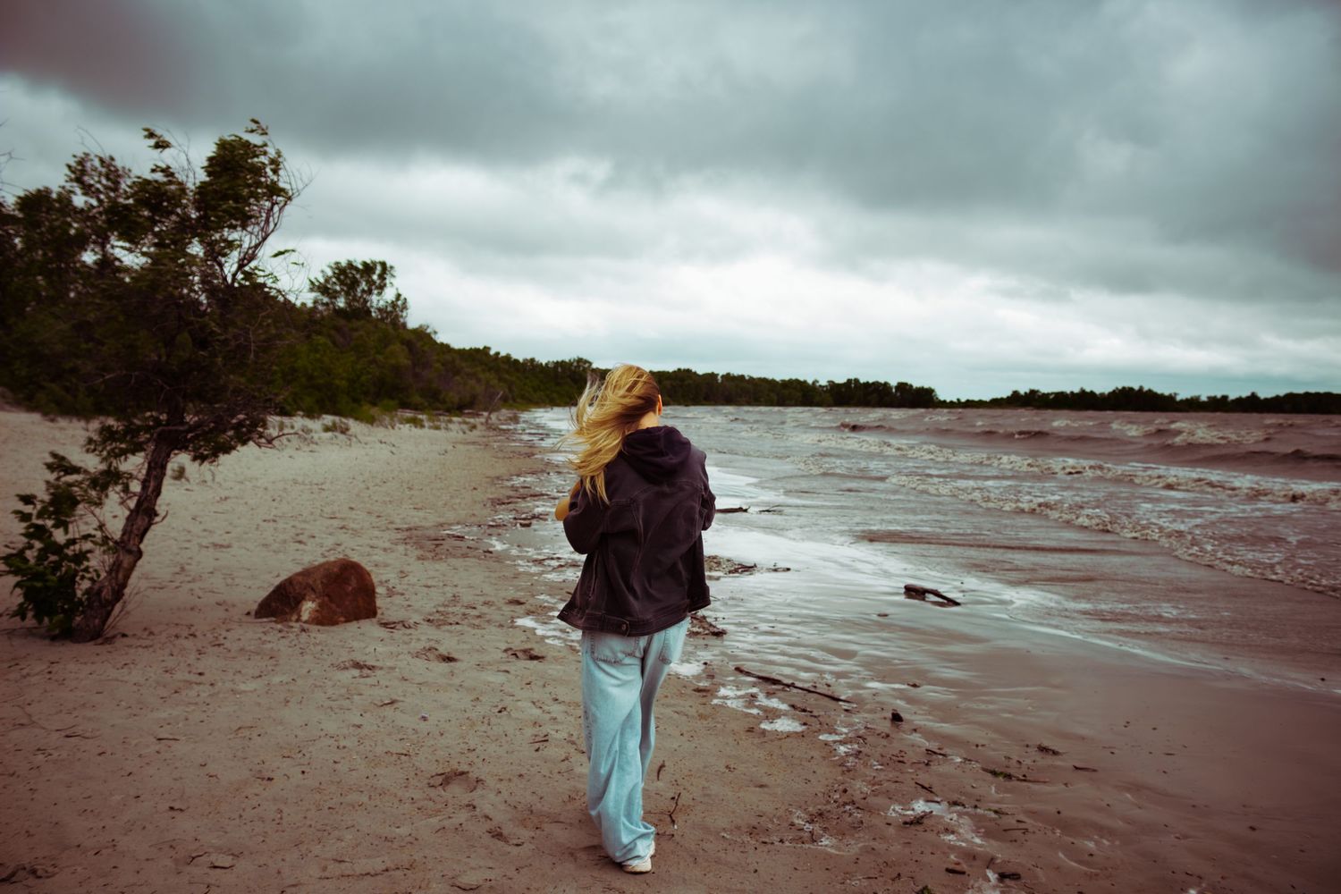 young woman posing at the beach