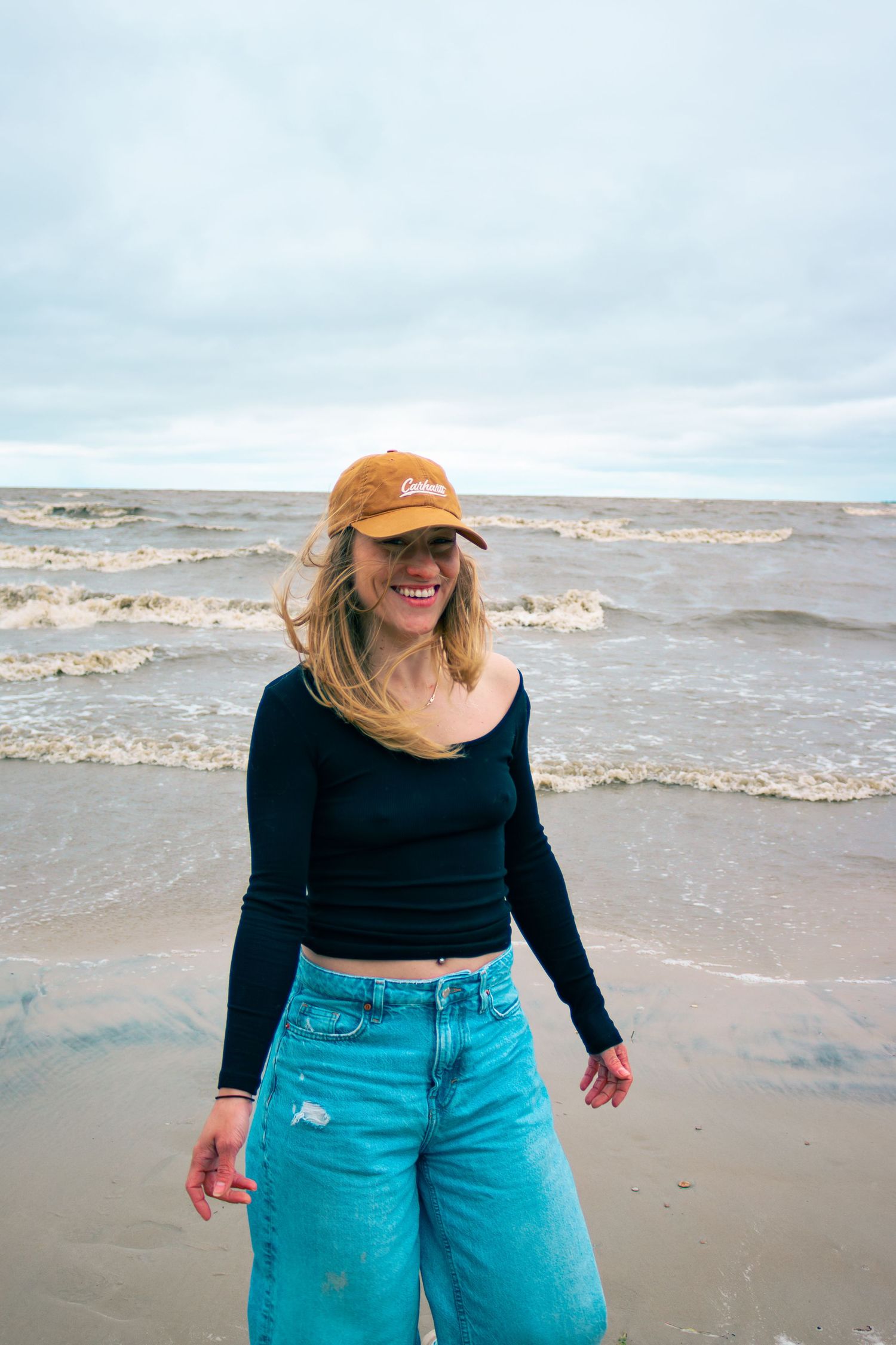 young woman posing at the beach