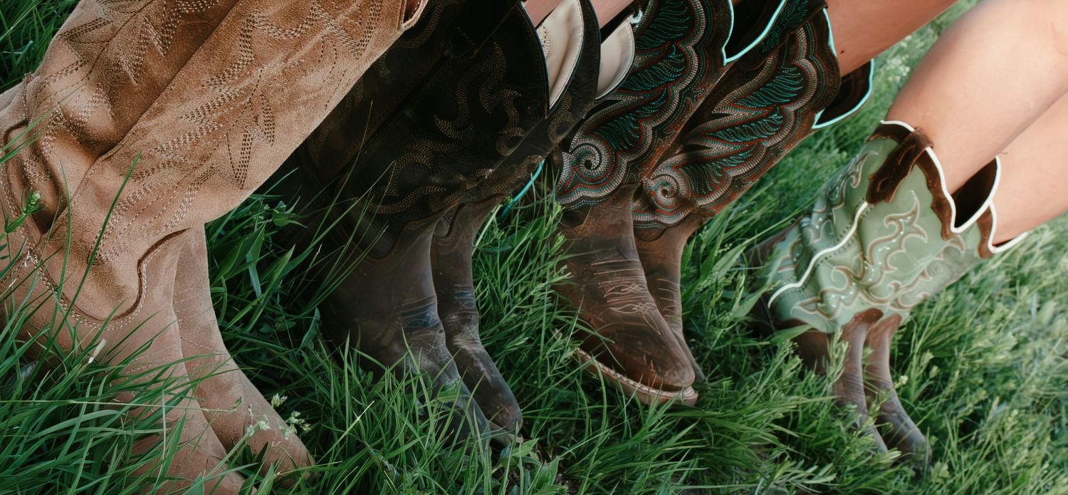 four pairs of cowboy boots posed in a line
