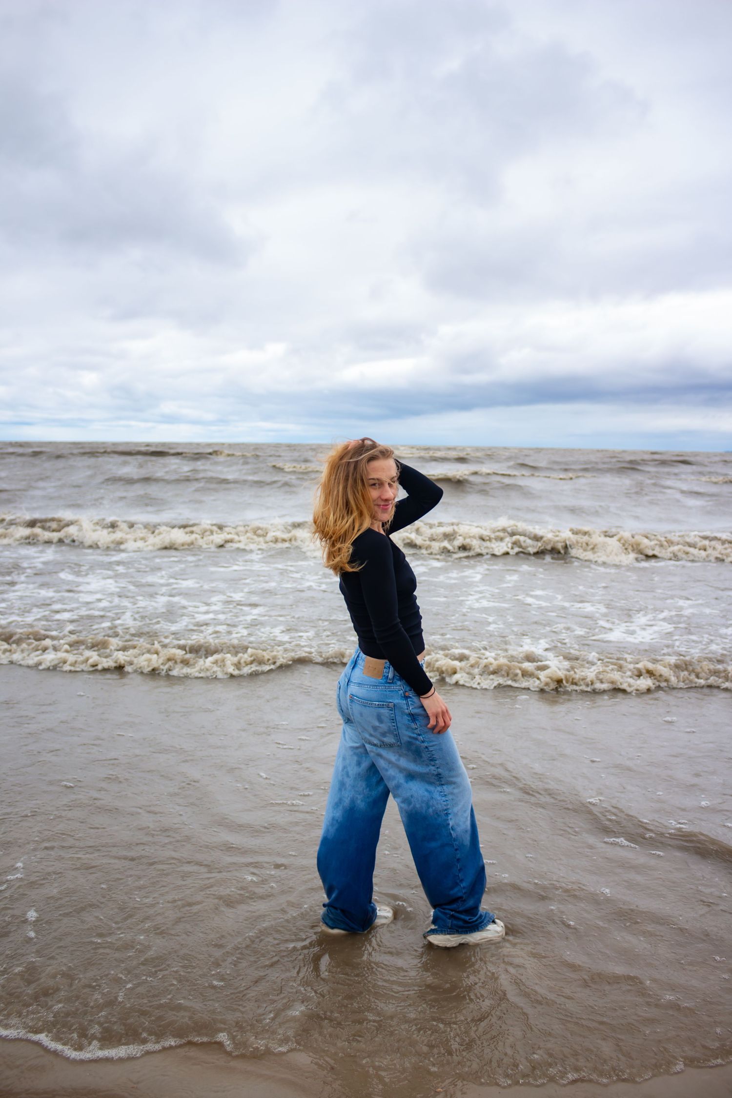 young woman posing at the beach
