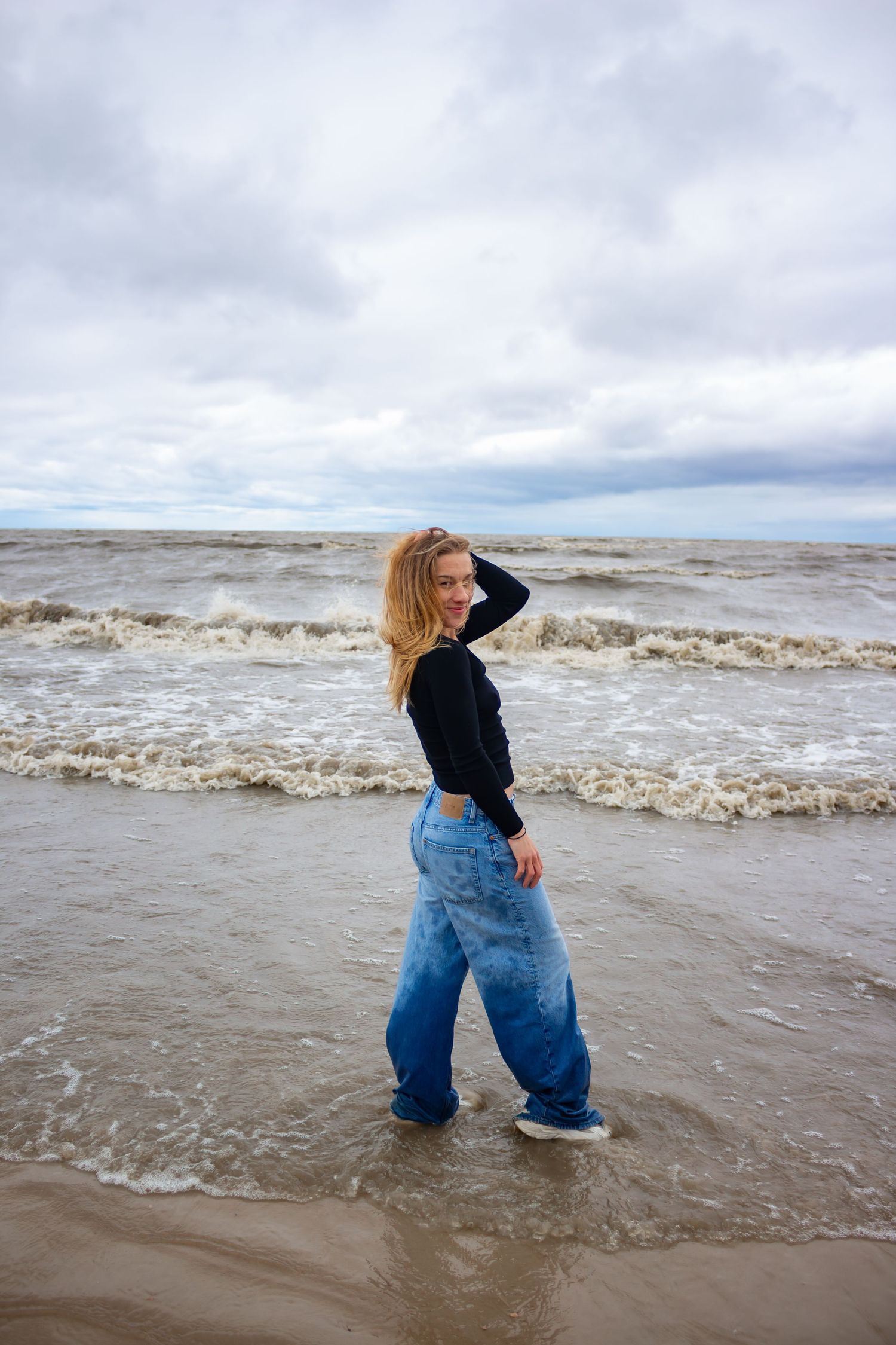 young woman posing at the beach