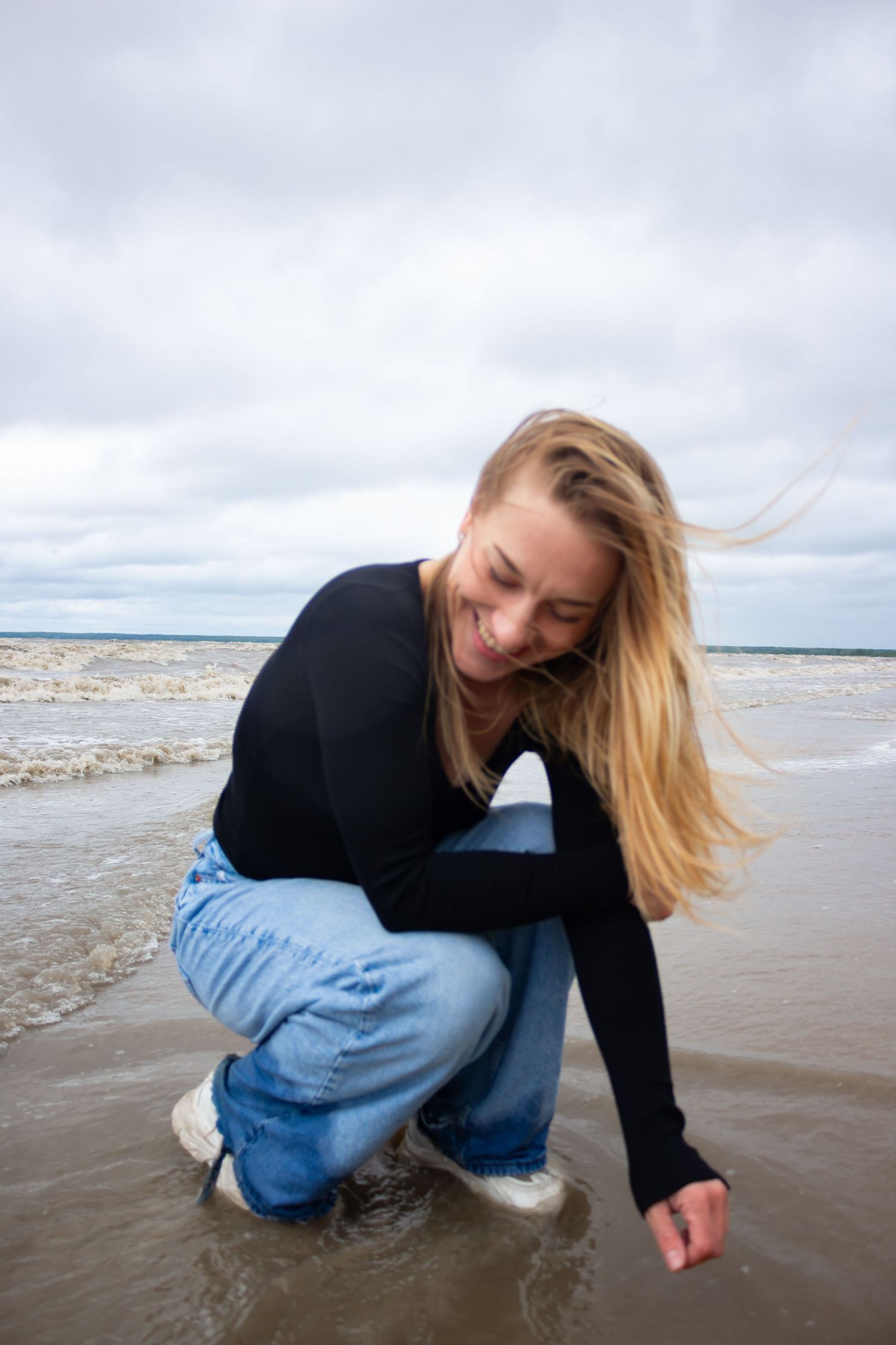 young woman posing at the beach