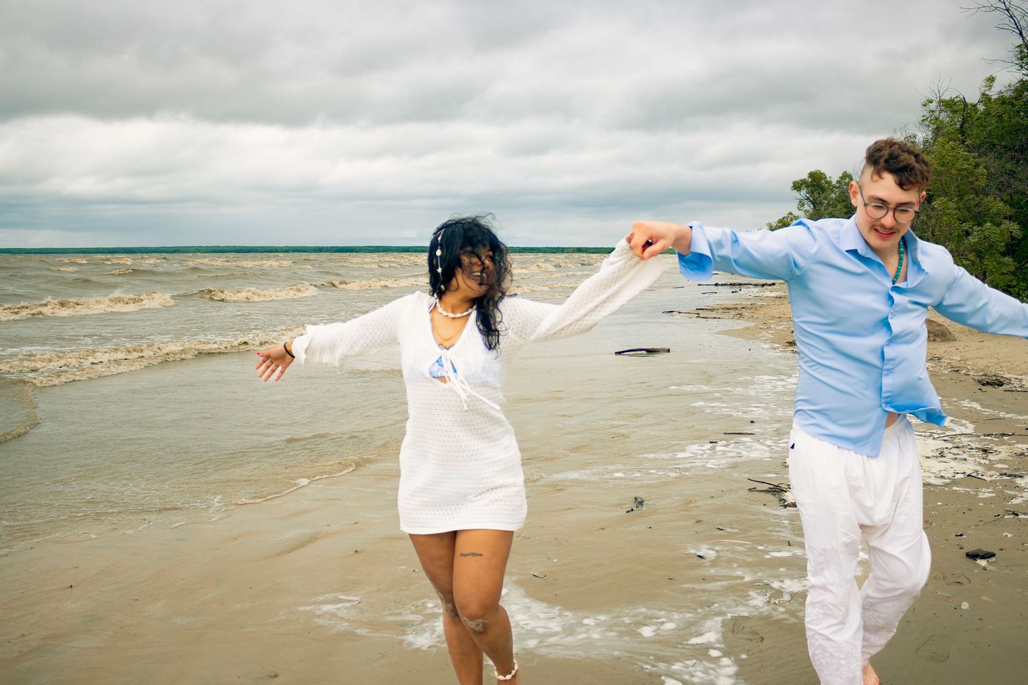 young couple posing at the beach