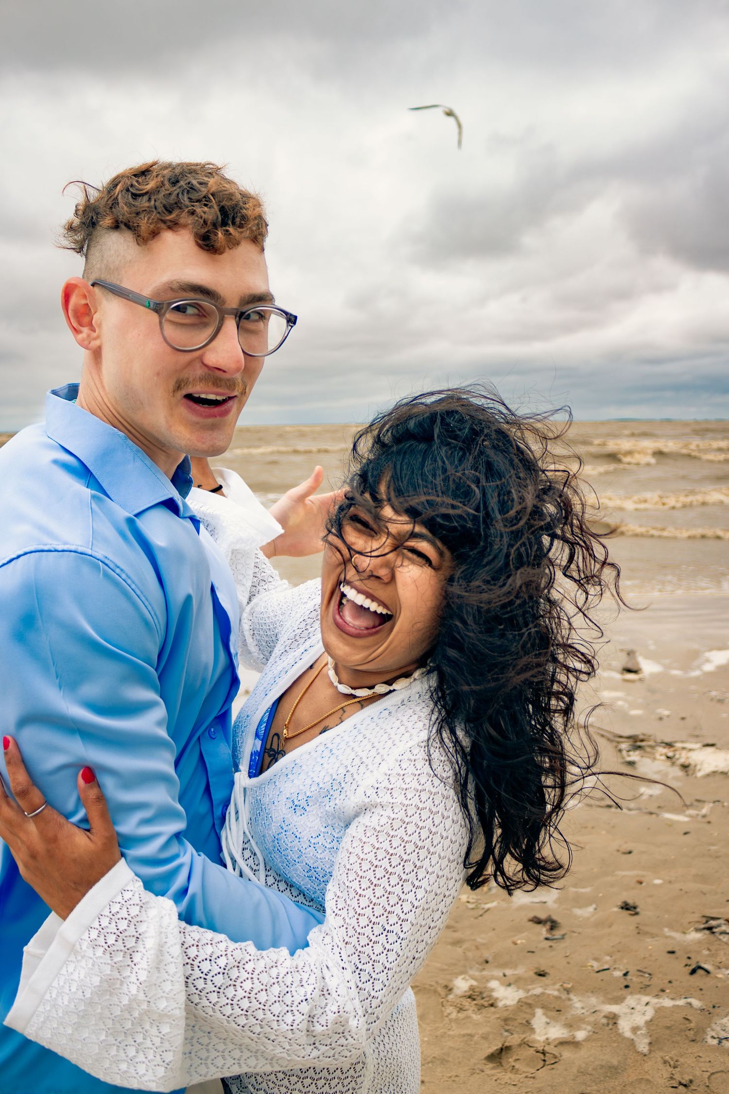 young couple posing at the beach