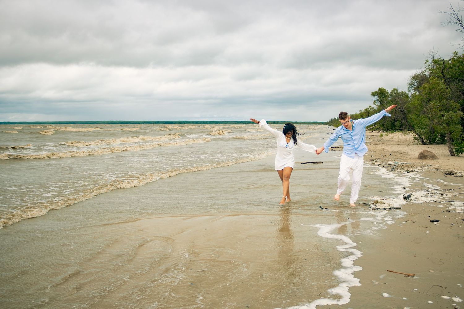 young couple posing at the beach