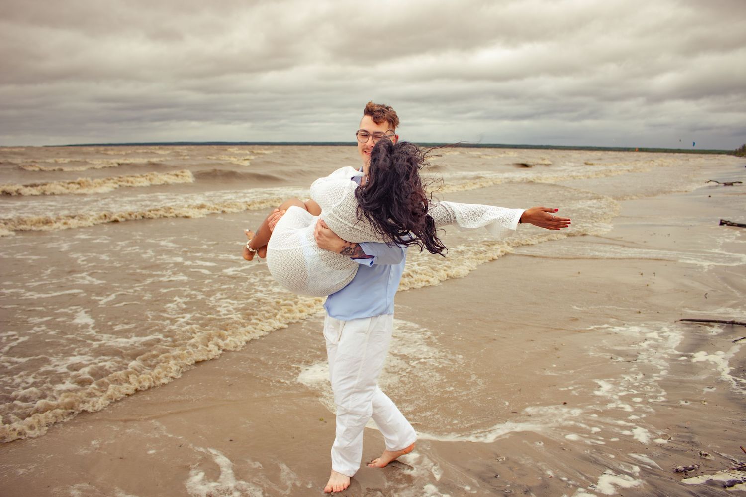 young couple posing at the beach