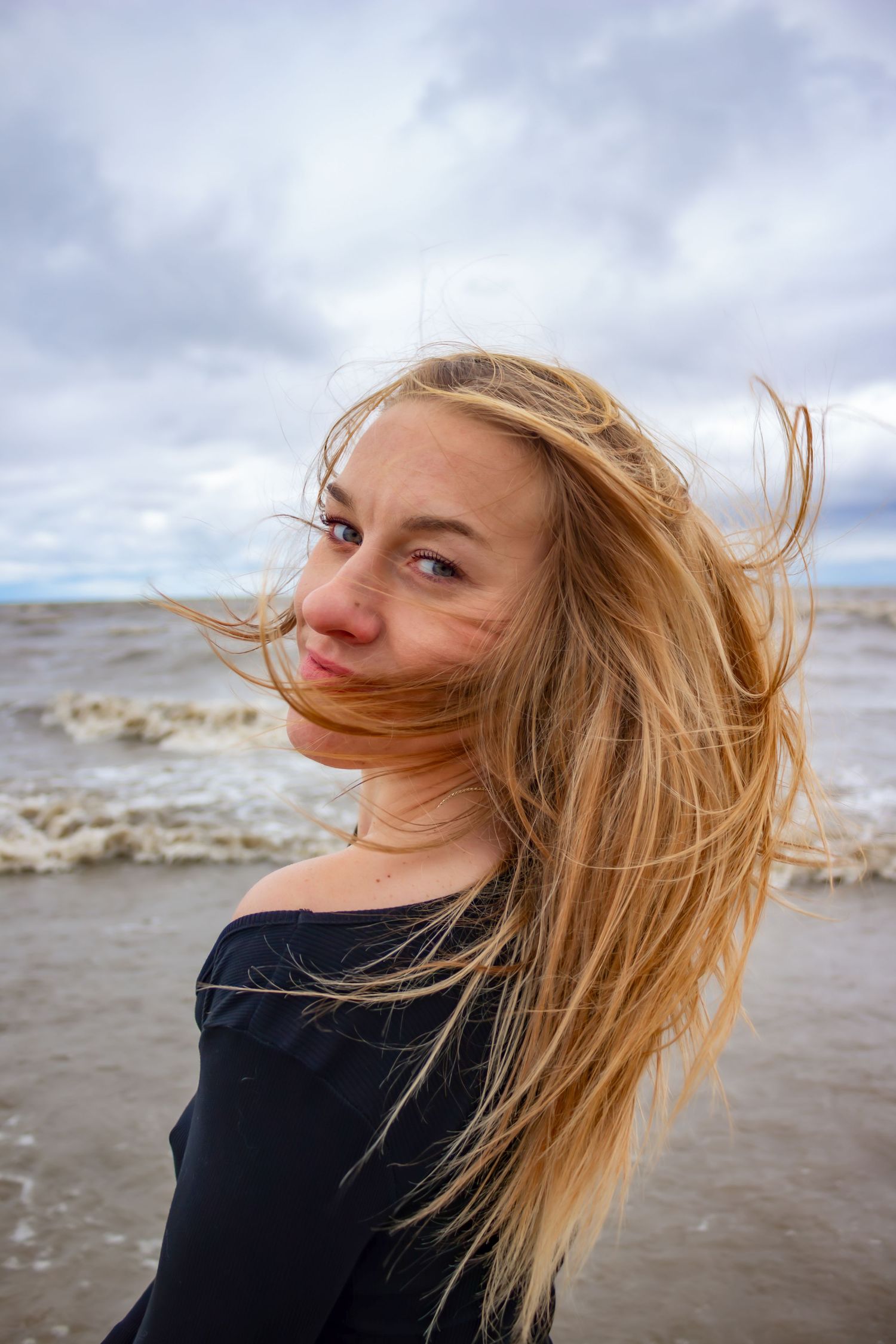 young woman posing at the beach