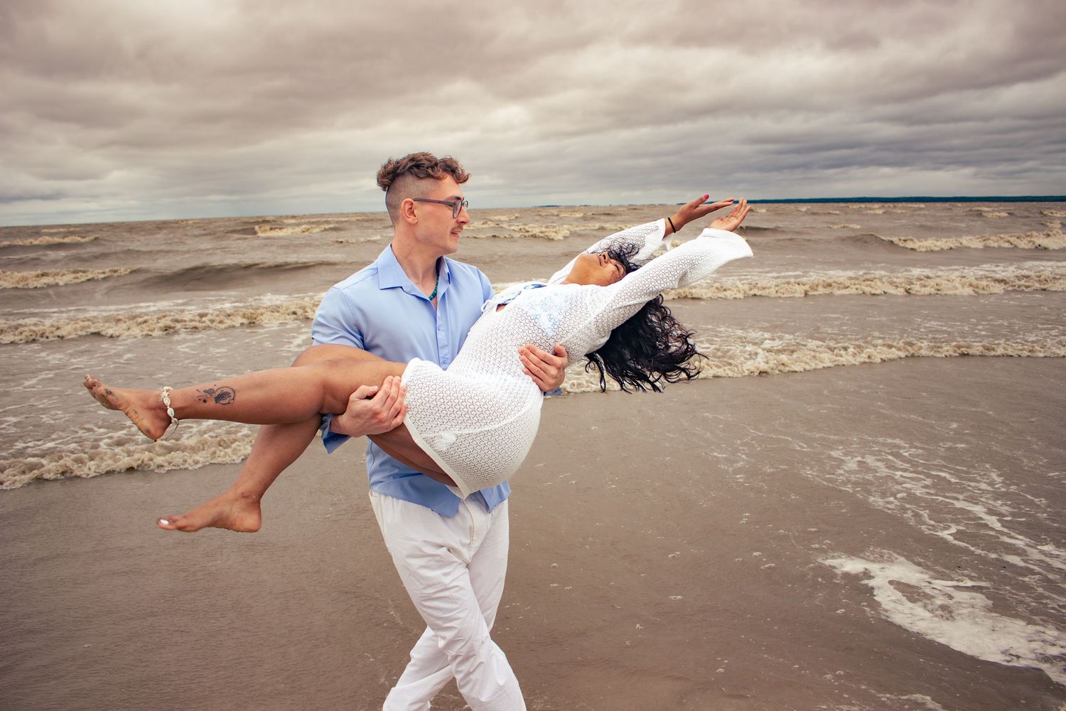 young couple posing at the beach