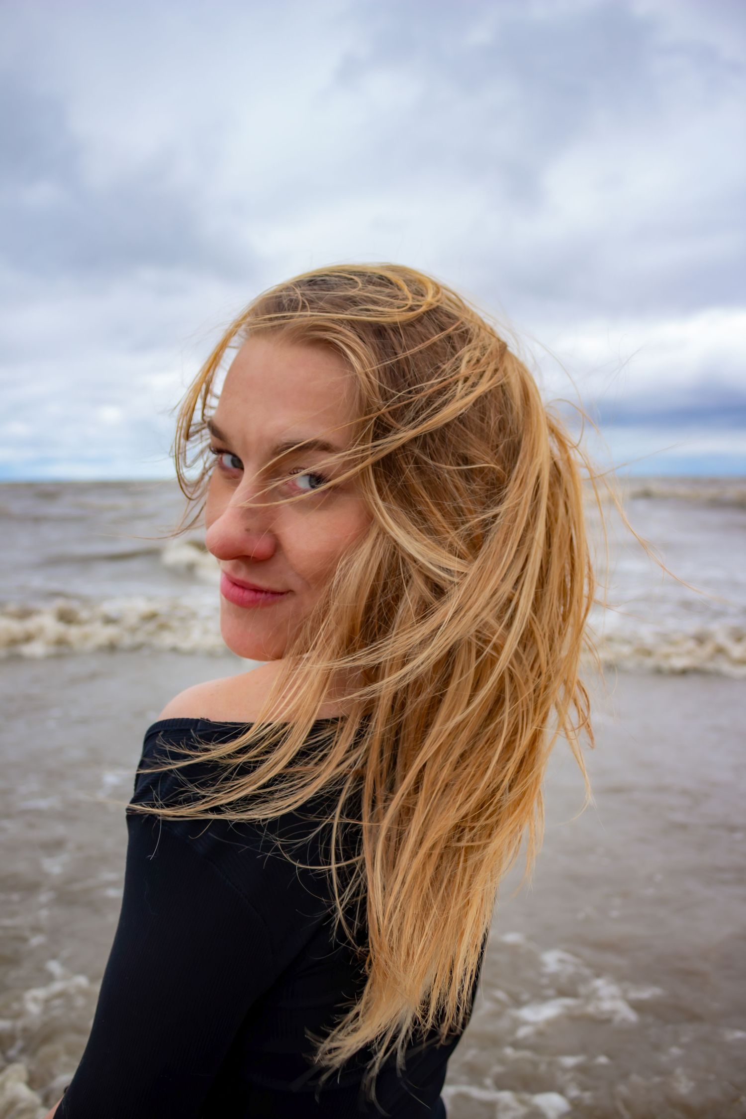 young woman posing at the beach