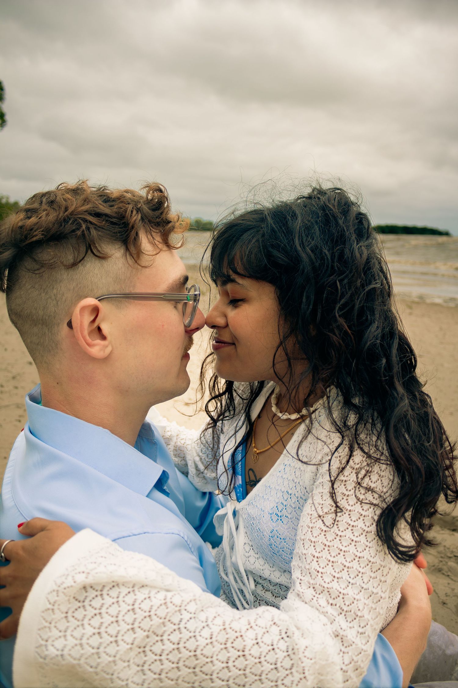 young couple posing at the beach