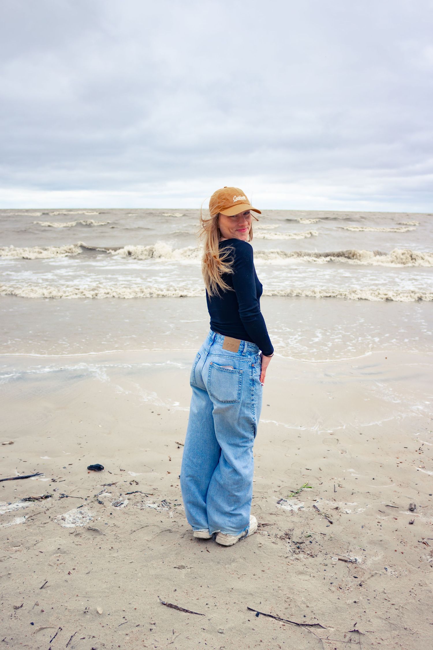 young woman posing at the beach