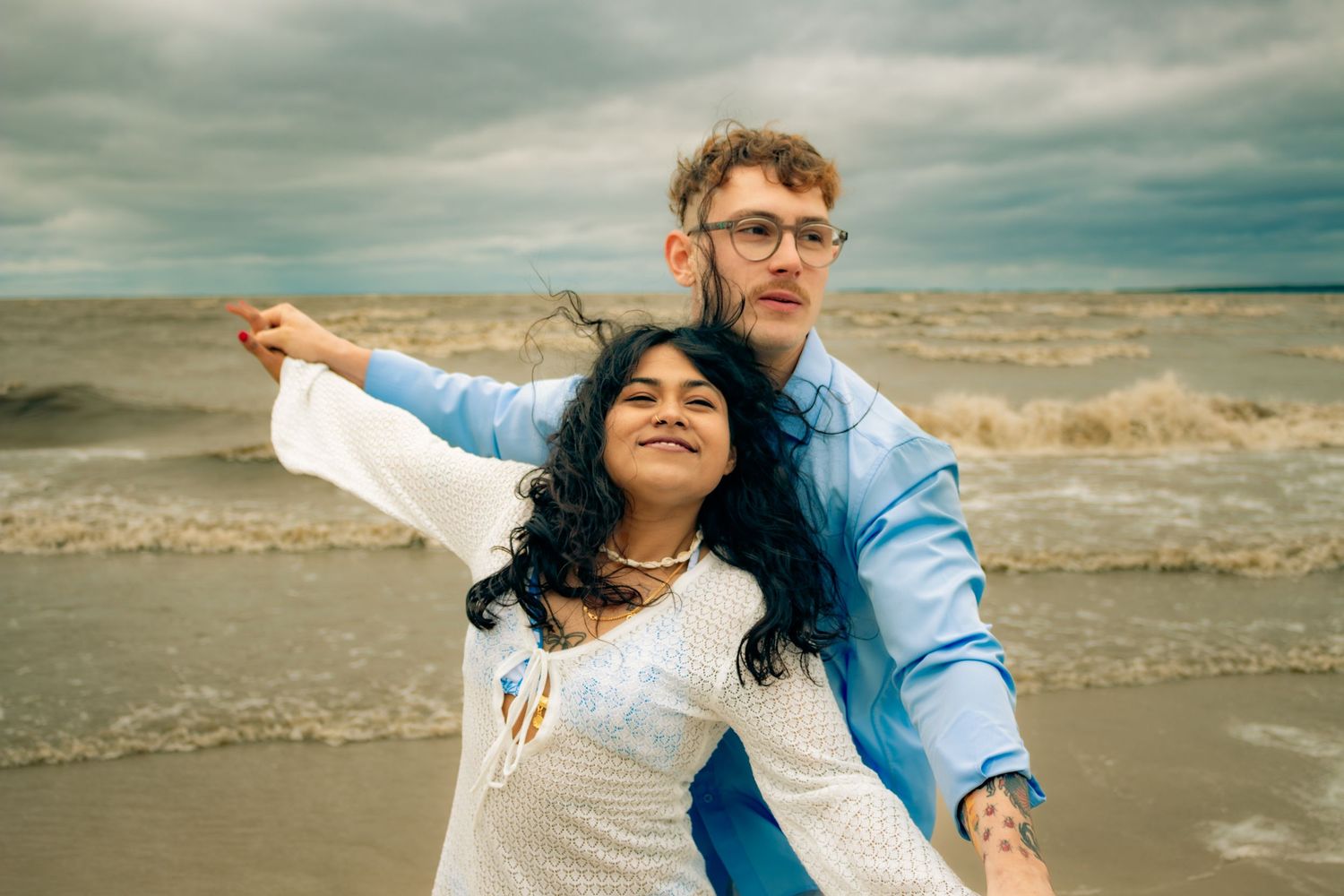 young couple posing at the beach