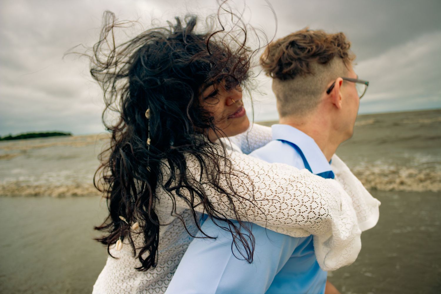 young couple posing at the beach
