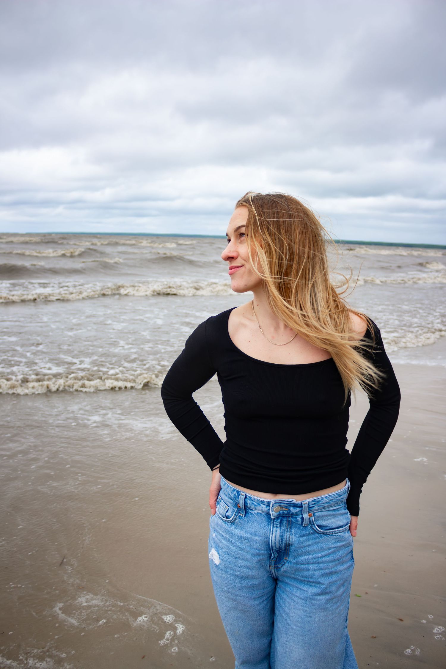 young woman posing at the beach