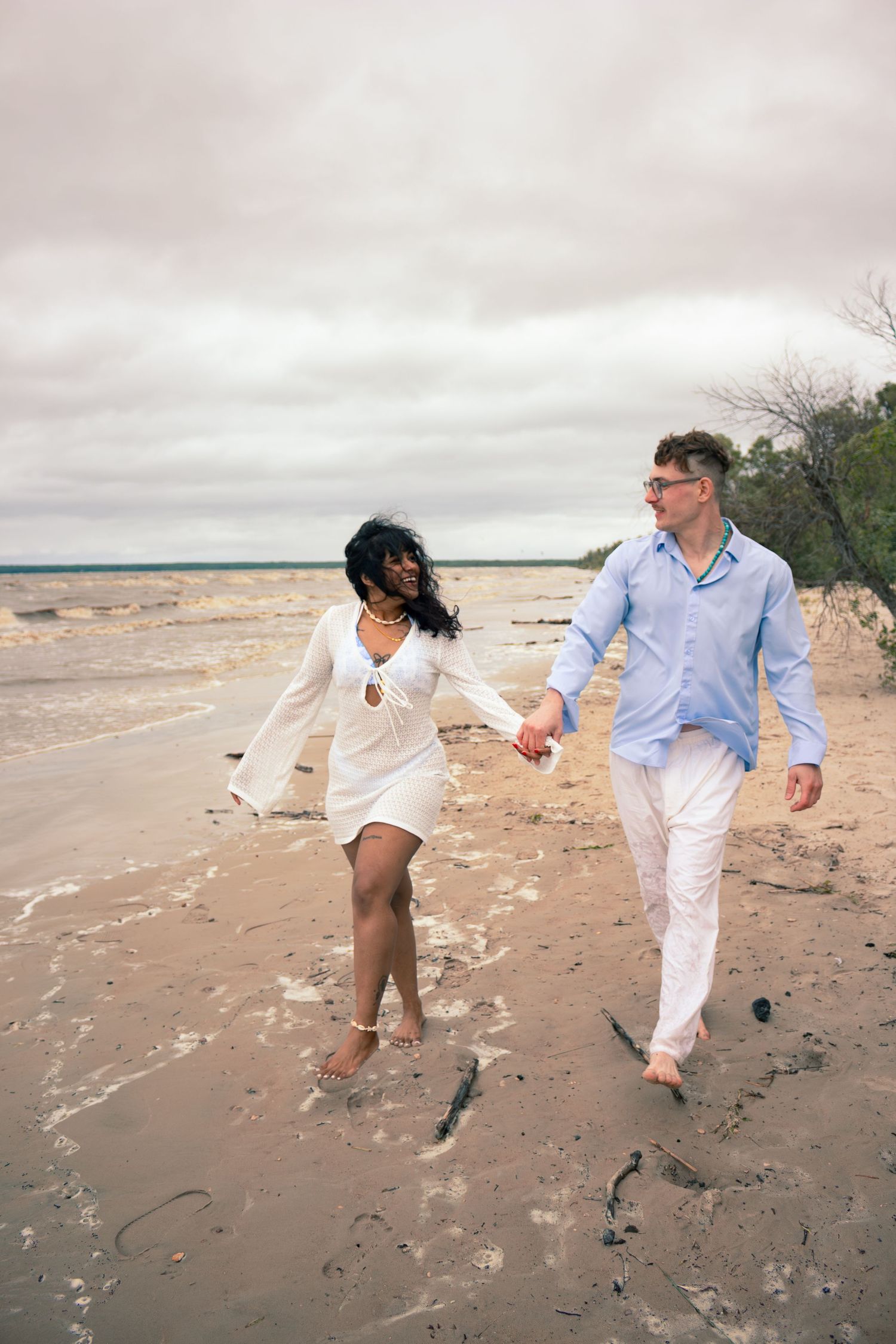 young couple posing at the beach