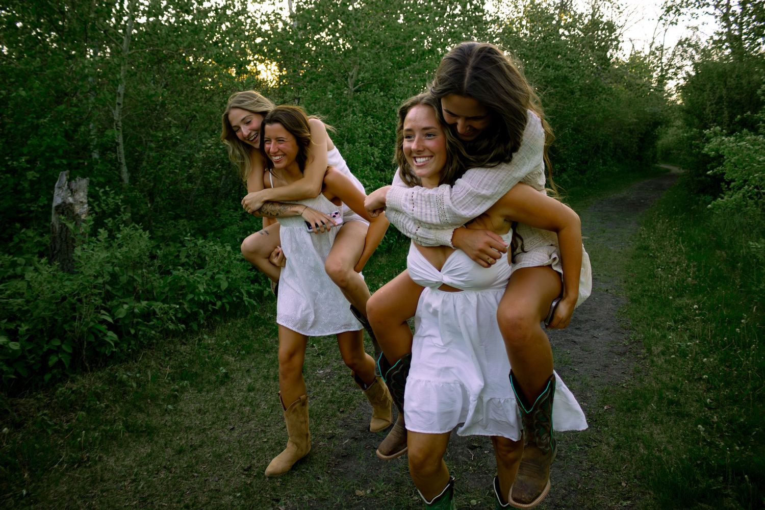 four female friends posing in the forest