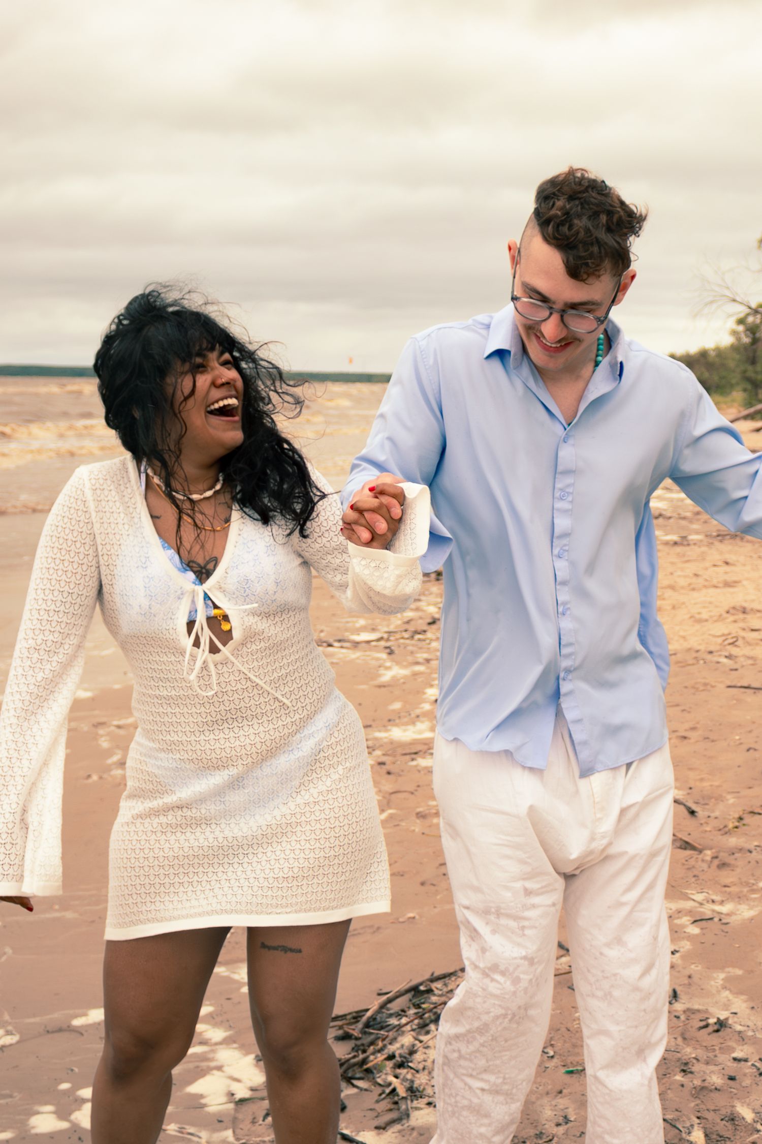 young couple posing at the beach