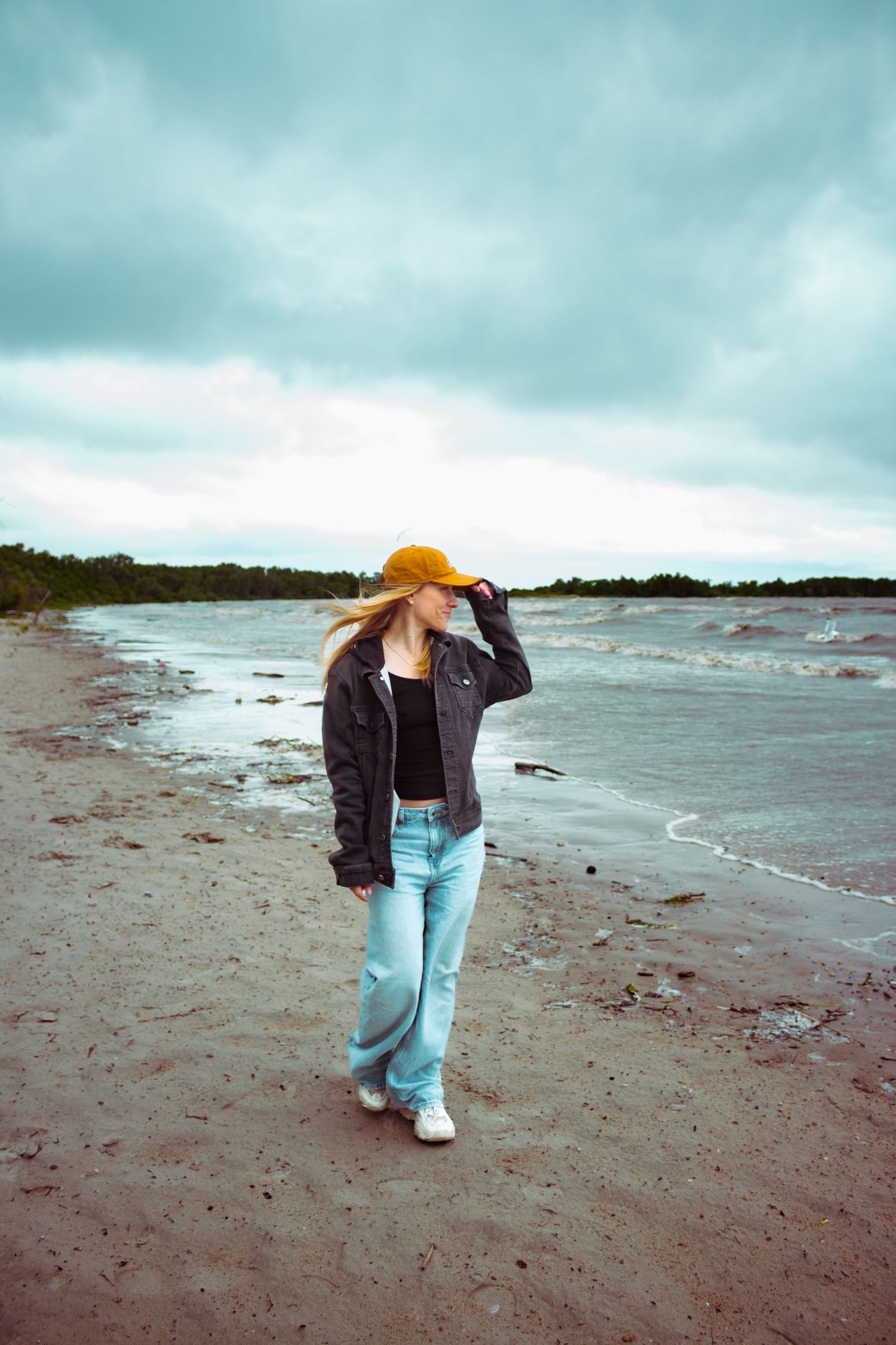 young woman posing at the beach