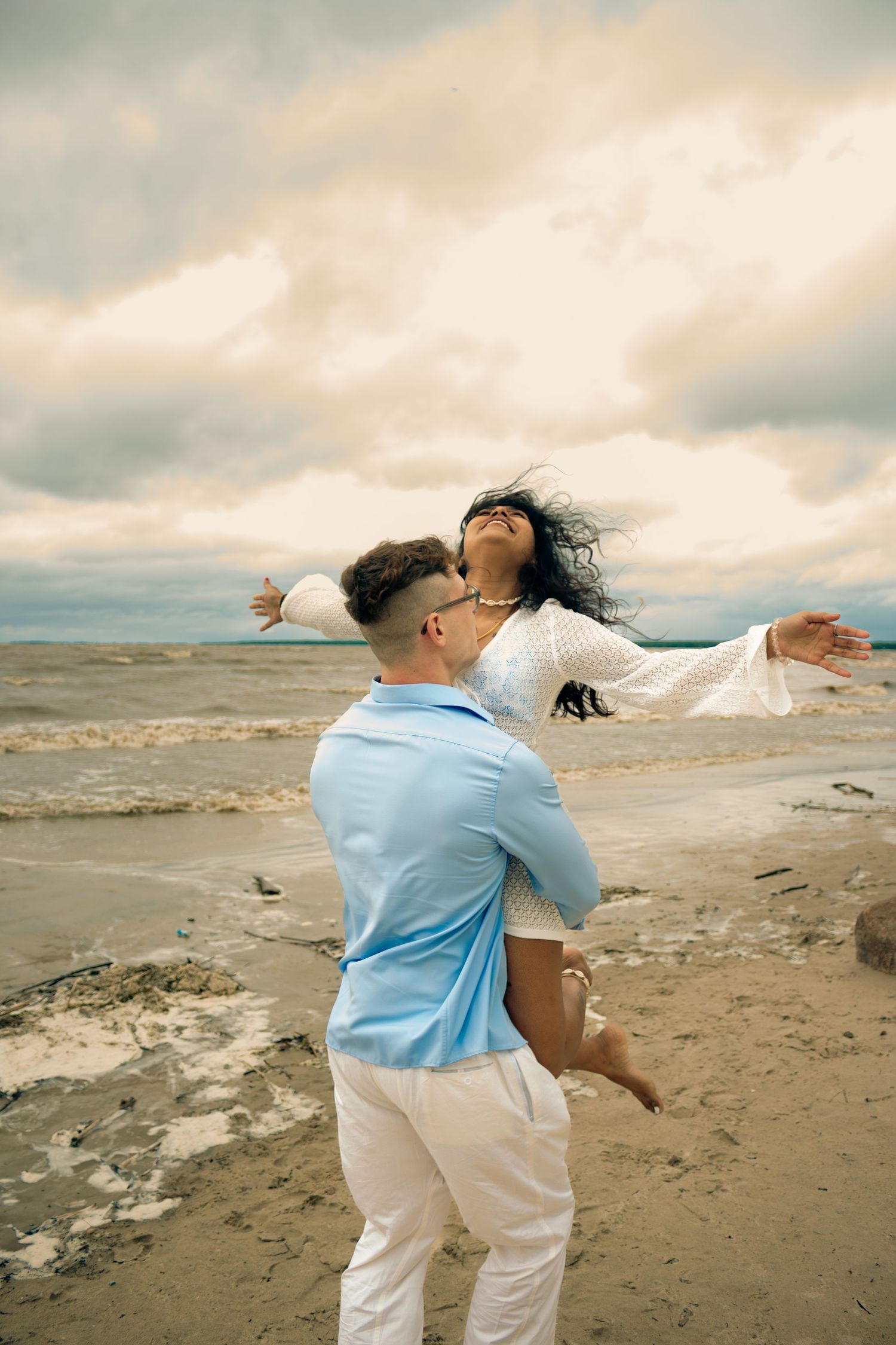 young couple posing at the beach