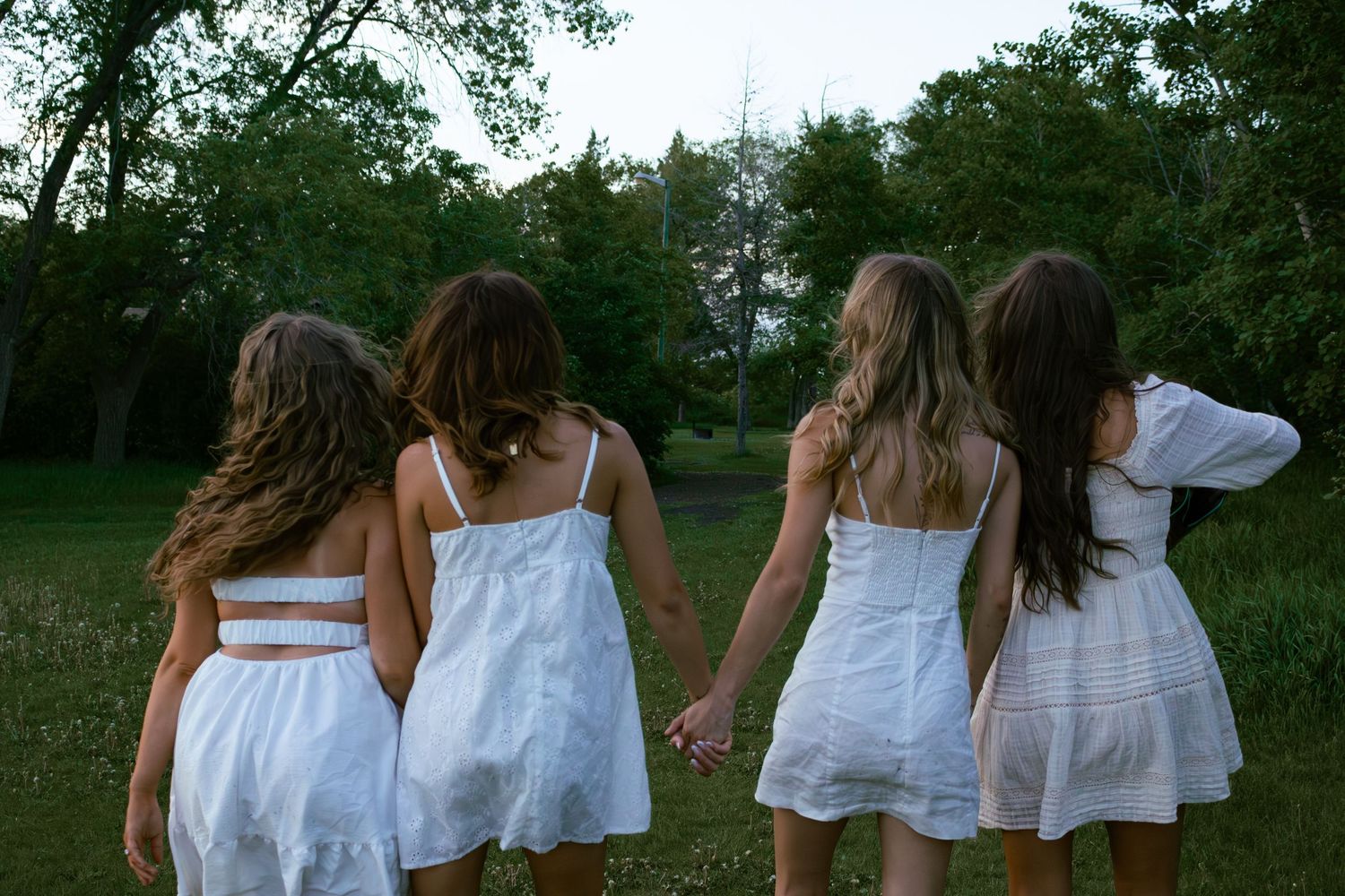 four ffemale friends walking in the forest